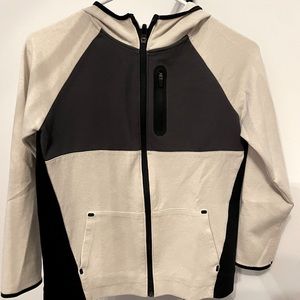 Cream colored and Black, Zip up jacket with a hood.